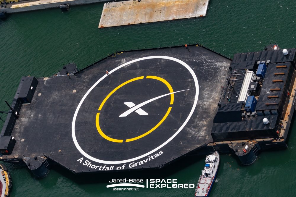 A Shortfall of Gravitas and SpaceX logo painted on ship deck.